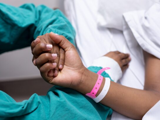 revna image of a doctor holding a patients hand. revna_patience